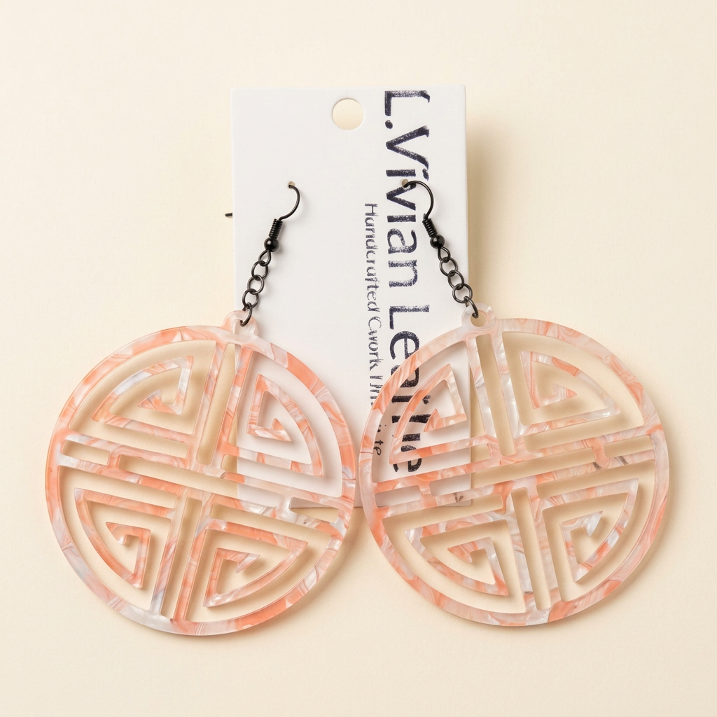 Pink circular earrings with an ivory background