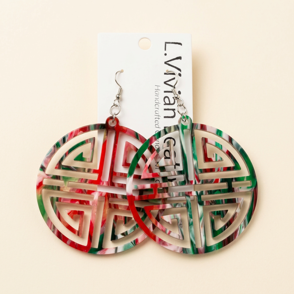 Red and green circular earrings with an ivory background