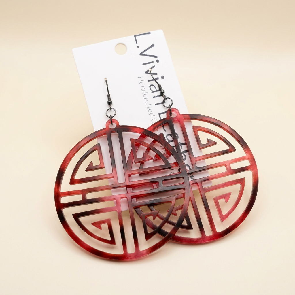 Red circular earrings with an ivory background